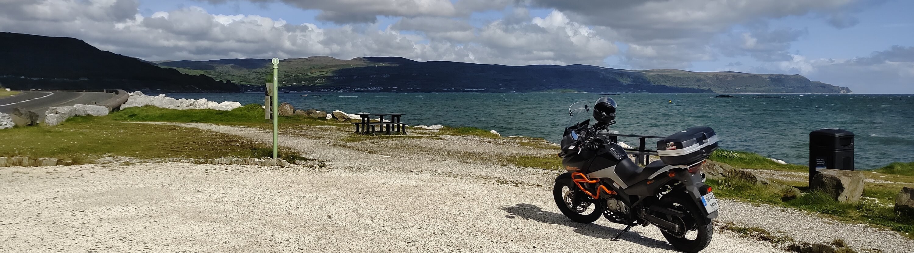 Vstrom 650 on edge of sea on Antrim Coast Road