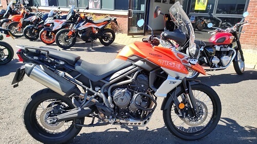 Orange and silver Triumph tiger 800 motorcycle